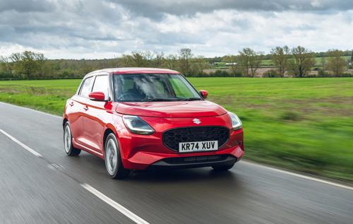 2025 suzuki swift red driving front three quarters