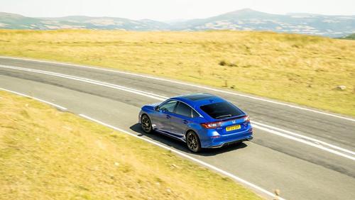 Honda Civic driving rear/side view