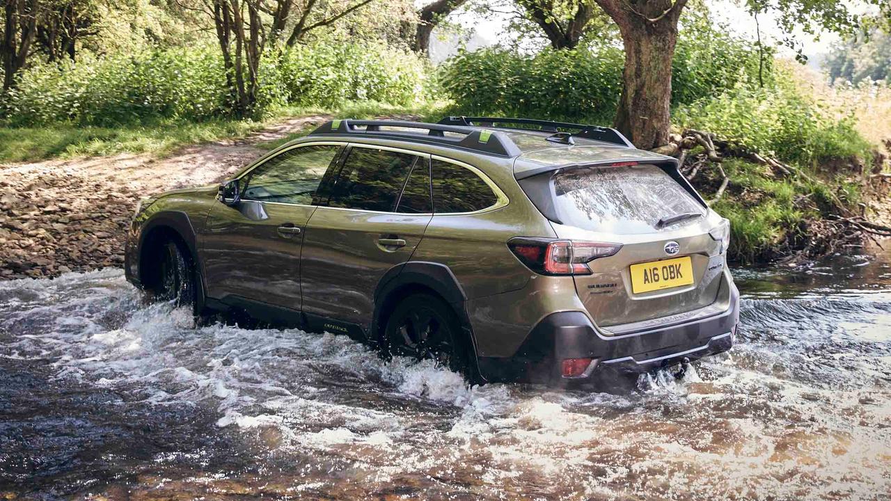 Subaru Outback driving through water – rear view