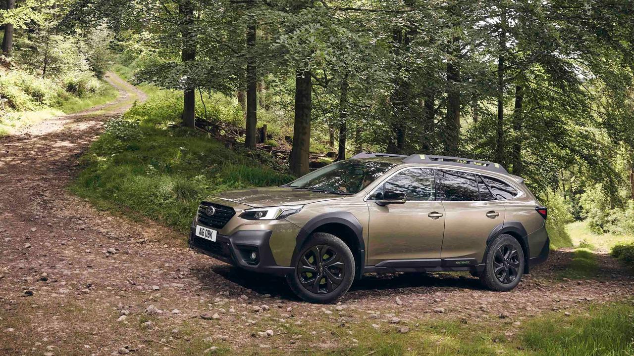 Subaru Outback driving up a forest trail