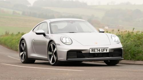 Silver Porsche 911 driving through countryside