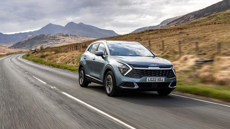 Kia Sportage being driven down a scenic road, probably in Scotland