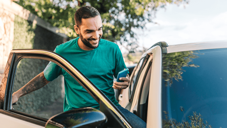 Happy man getting into car