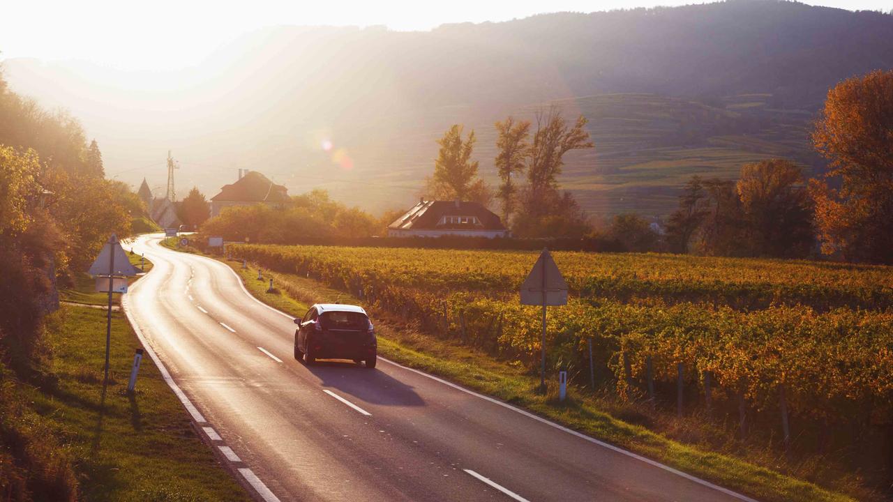 Car driving on a road in Europe, sunset