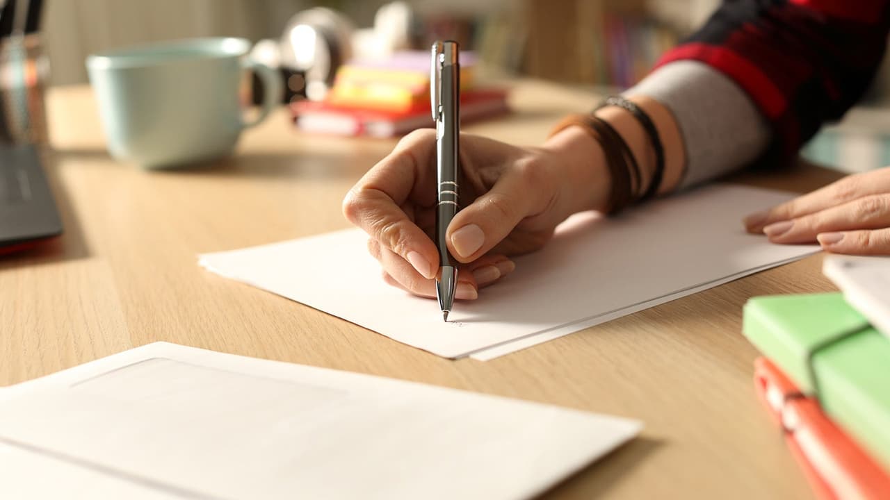 Person writing a letter