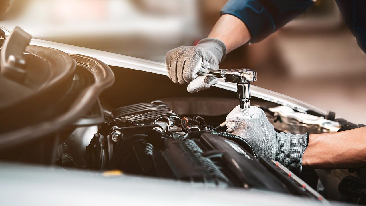 Technician servicing an engine bay