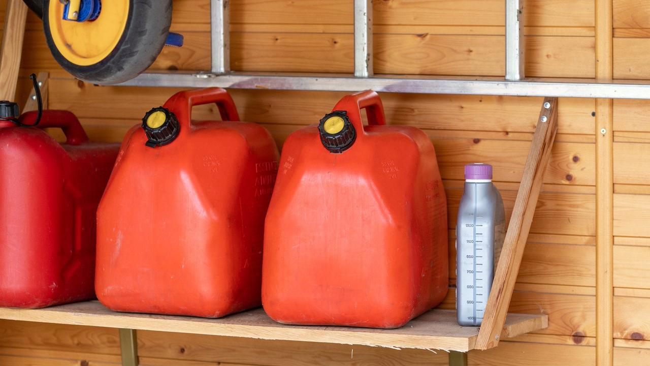 Jerry cans of fuel on a shelf in a shed