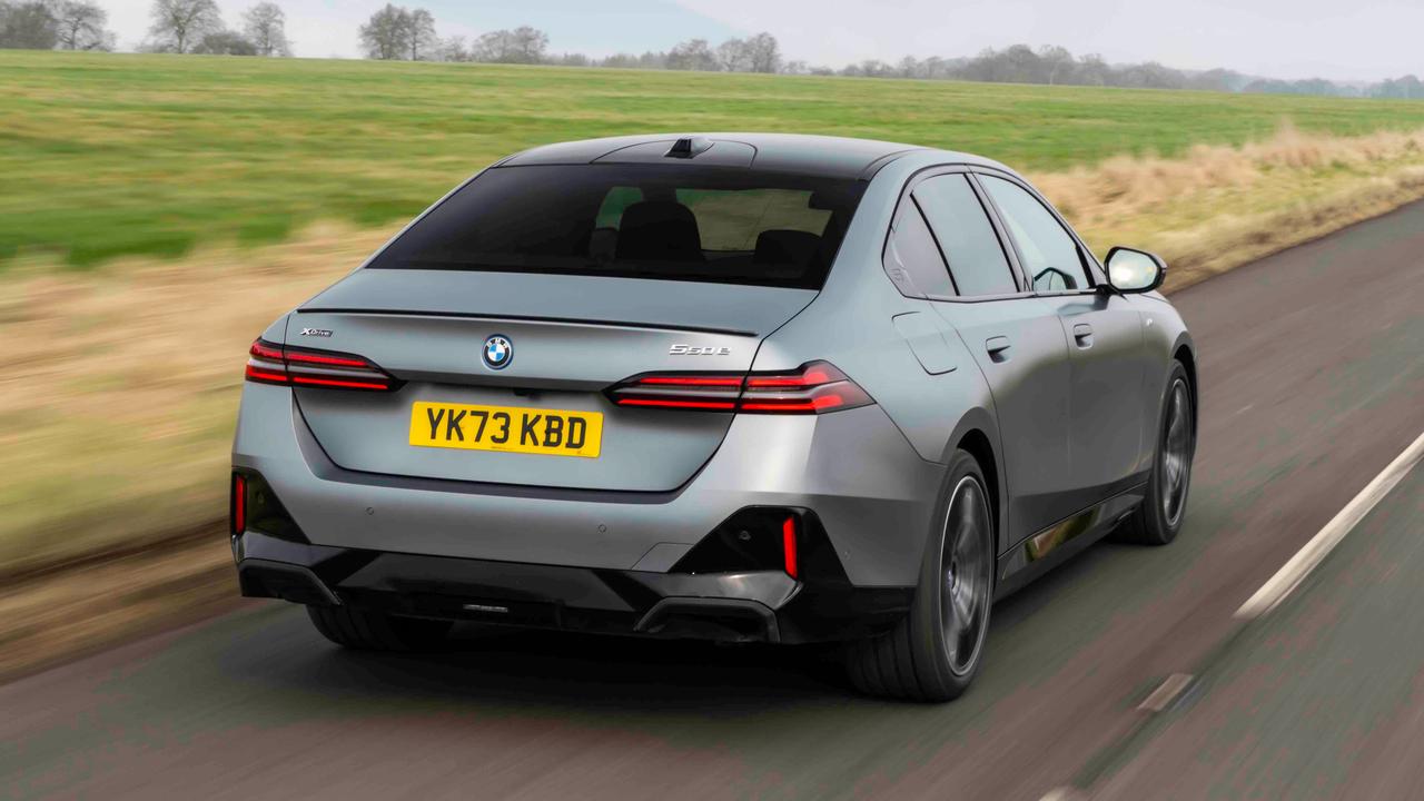 BMW 550e saloon driving, rear view