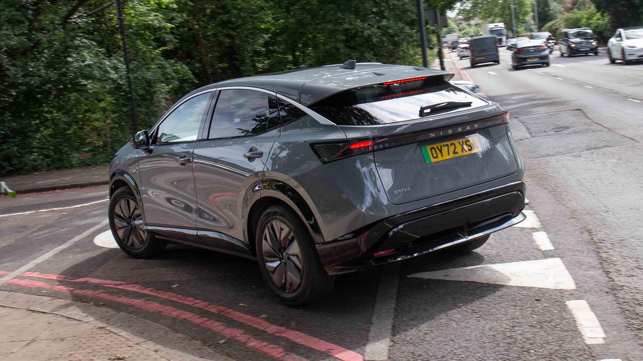 Nissan Ariya turning into London side street, rear view