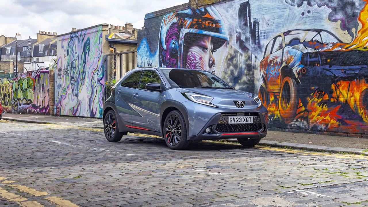 Toyota Aygo X in front of graffiti