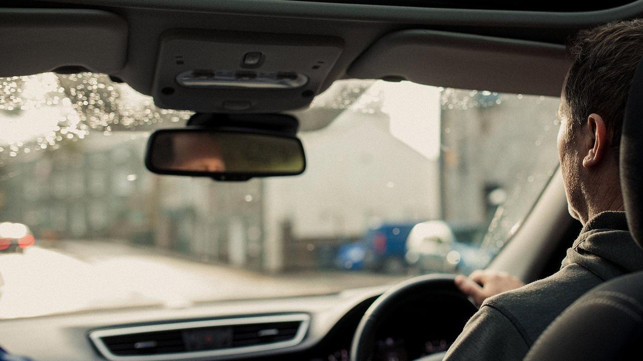 Over-shoulder shot of someone driving a car