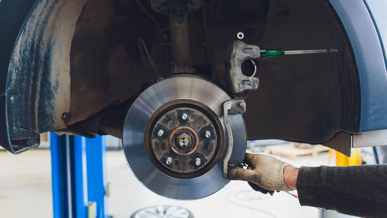Mechanic checking car brake
