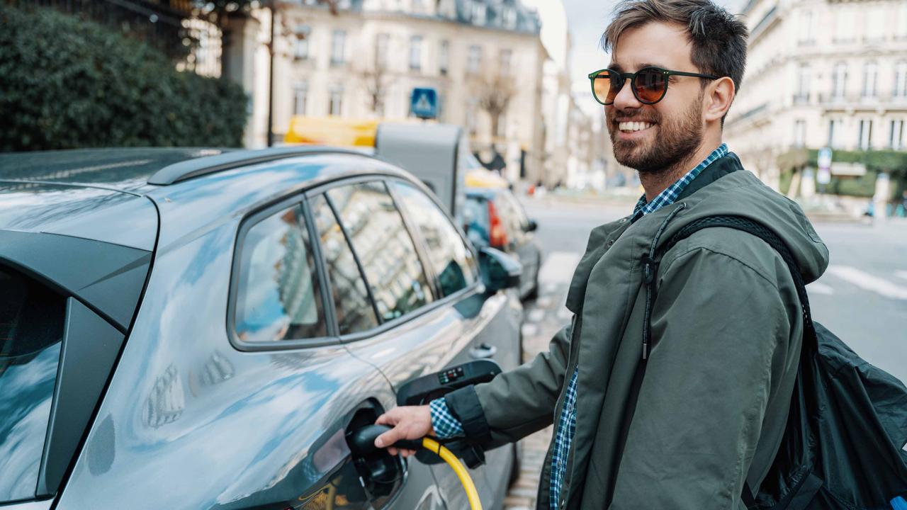 Man charging a Skoda Enyaq in France