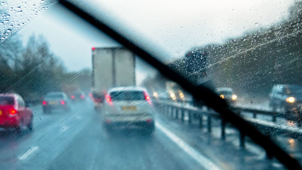 Wet UK motorway seen from behind the wheel