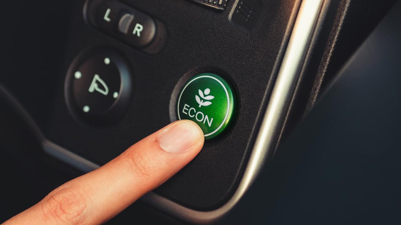 Person pressing eco mode button
