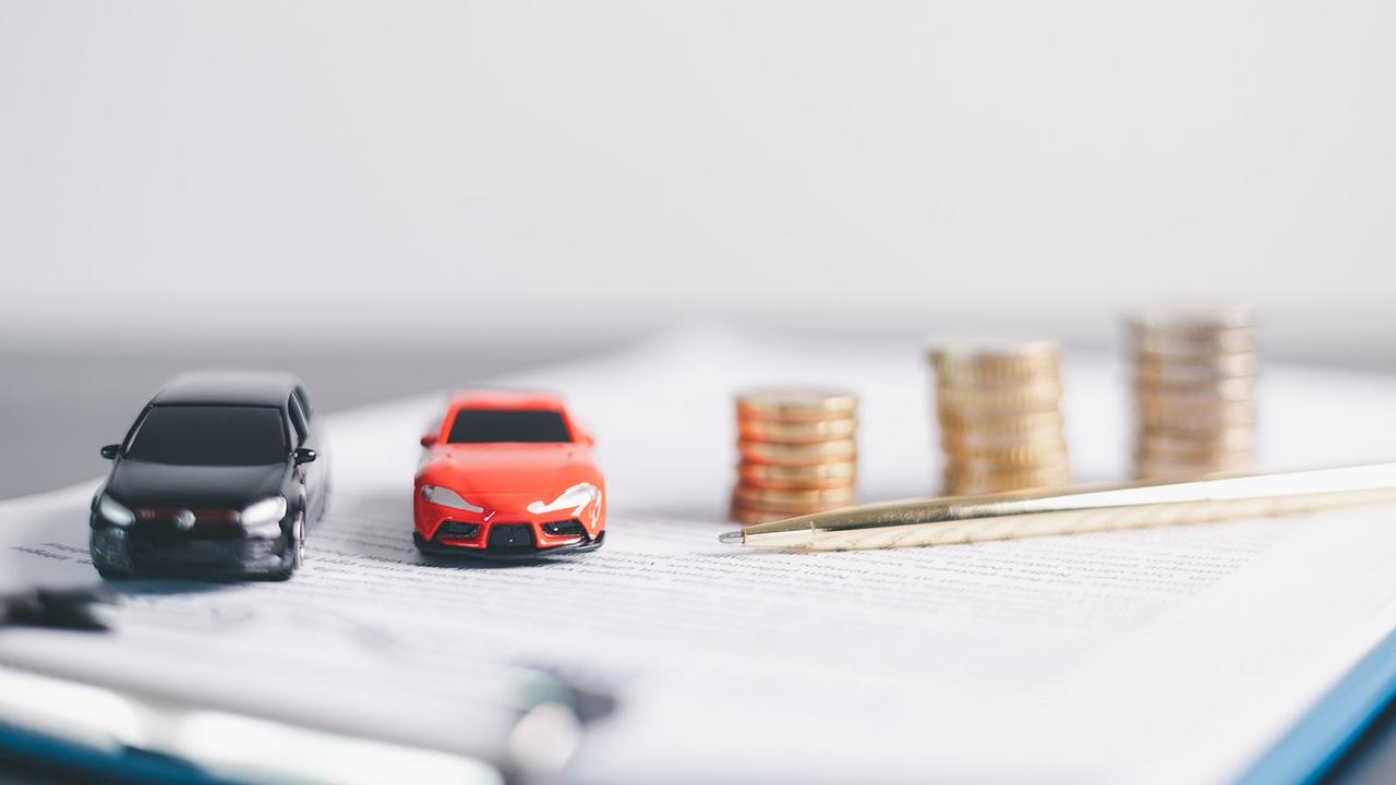 Toy cars next to money