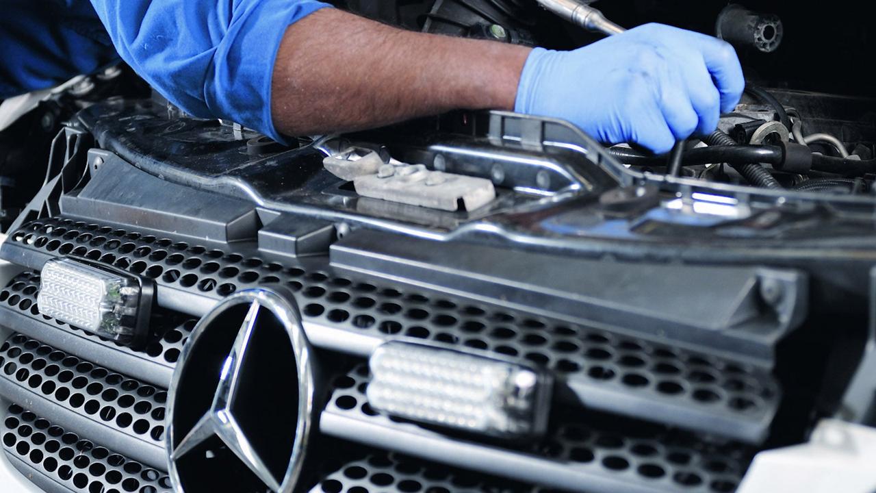 Mercedes technician working on engine