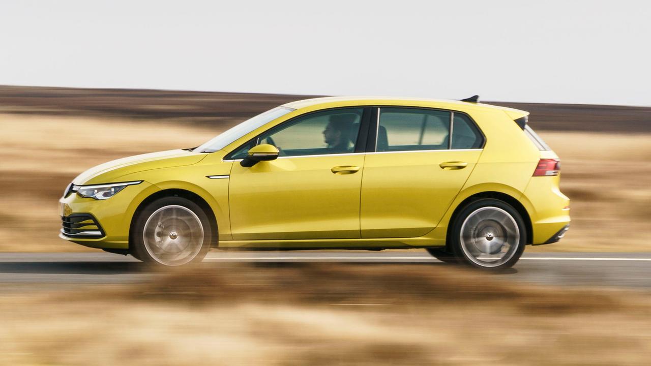 Volkswagen Golf driving, side view, in Lime Yellow