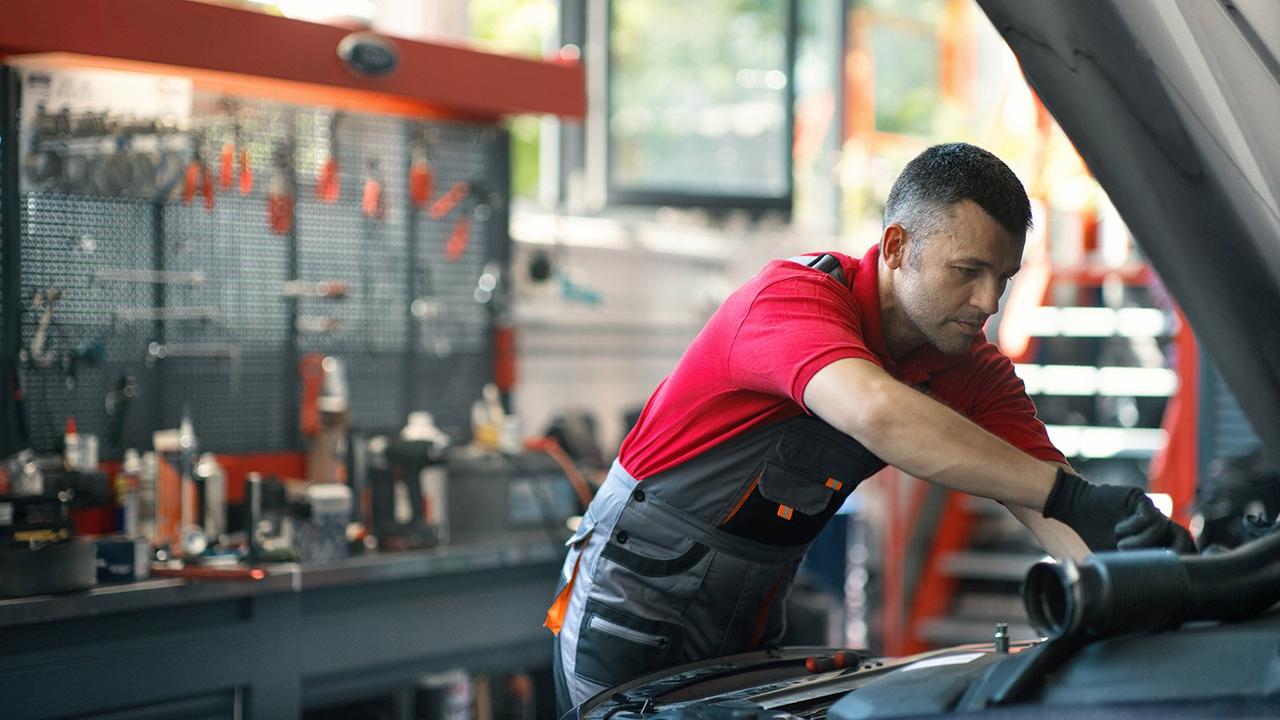 Person servicing car filter
