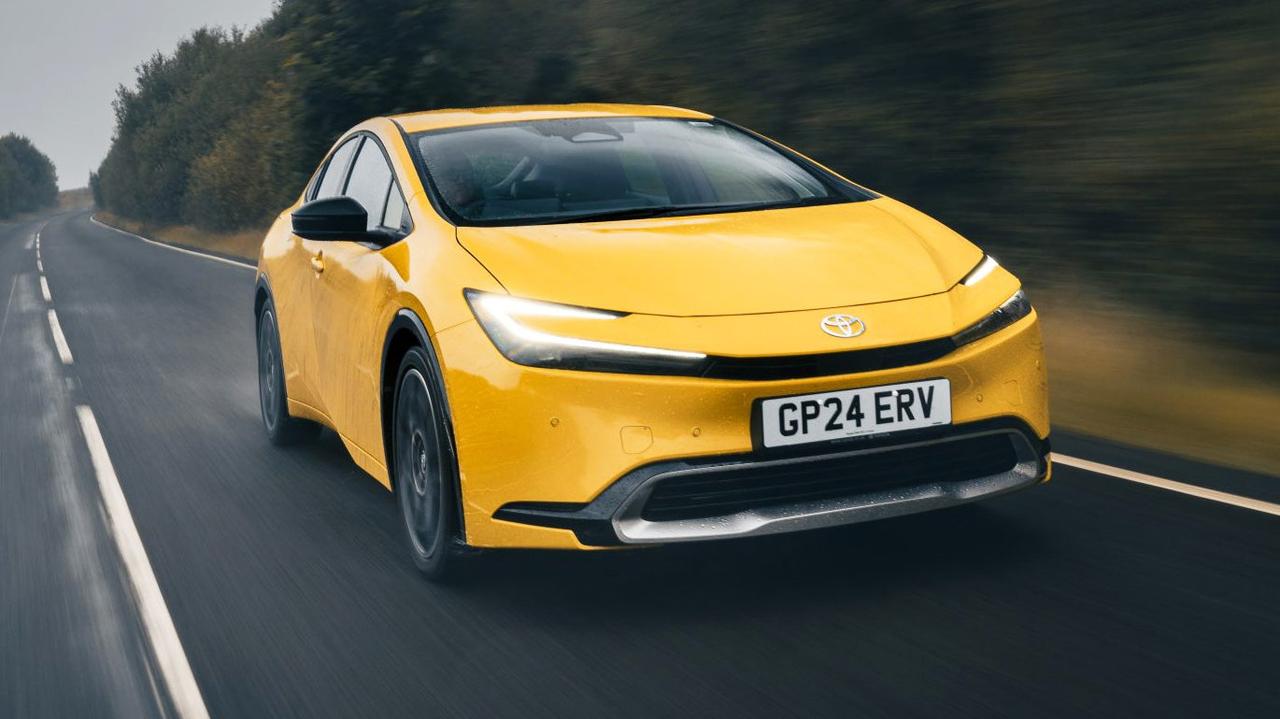 2024 Toyota Prius driving, yellow