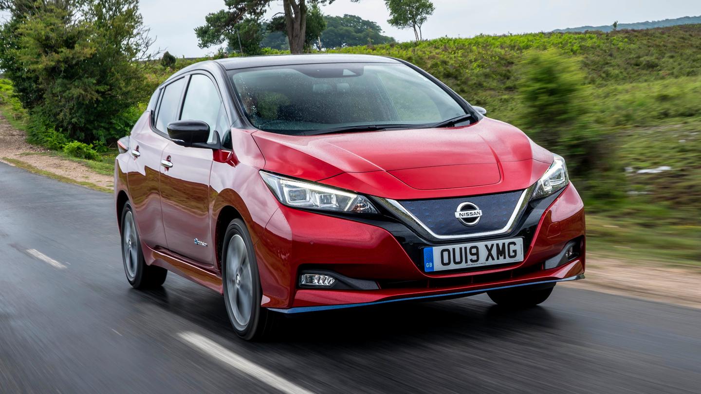 red nissan leaf driving