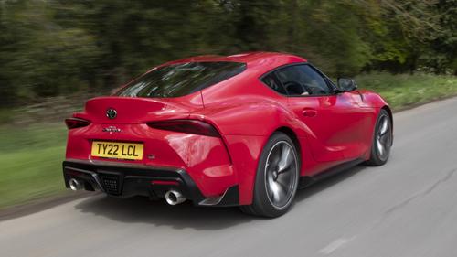 Toyota GR Supra driving rear/side view