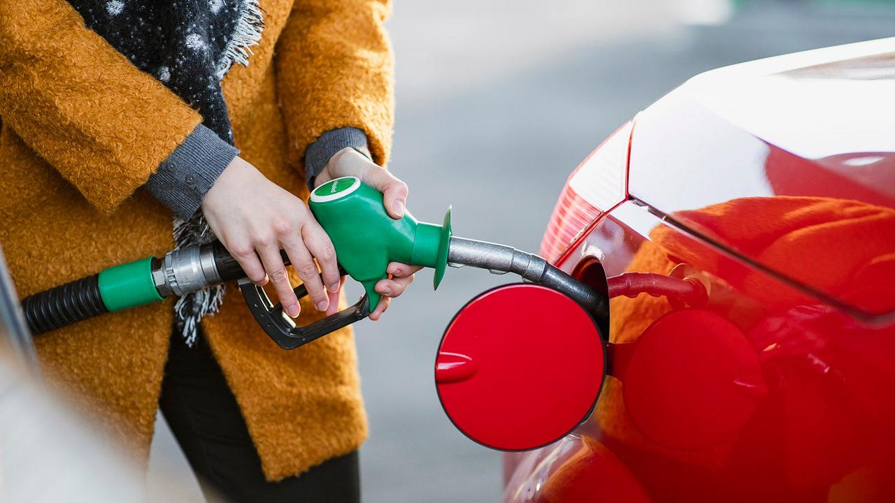 Driver filling car with unleaded petrol