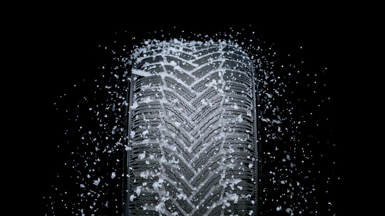 Car tyre closeup with snow in treads