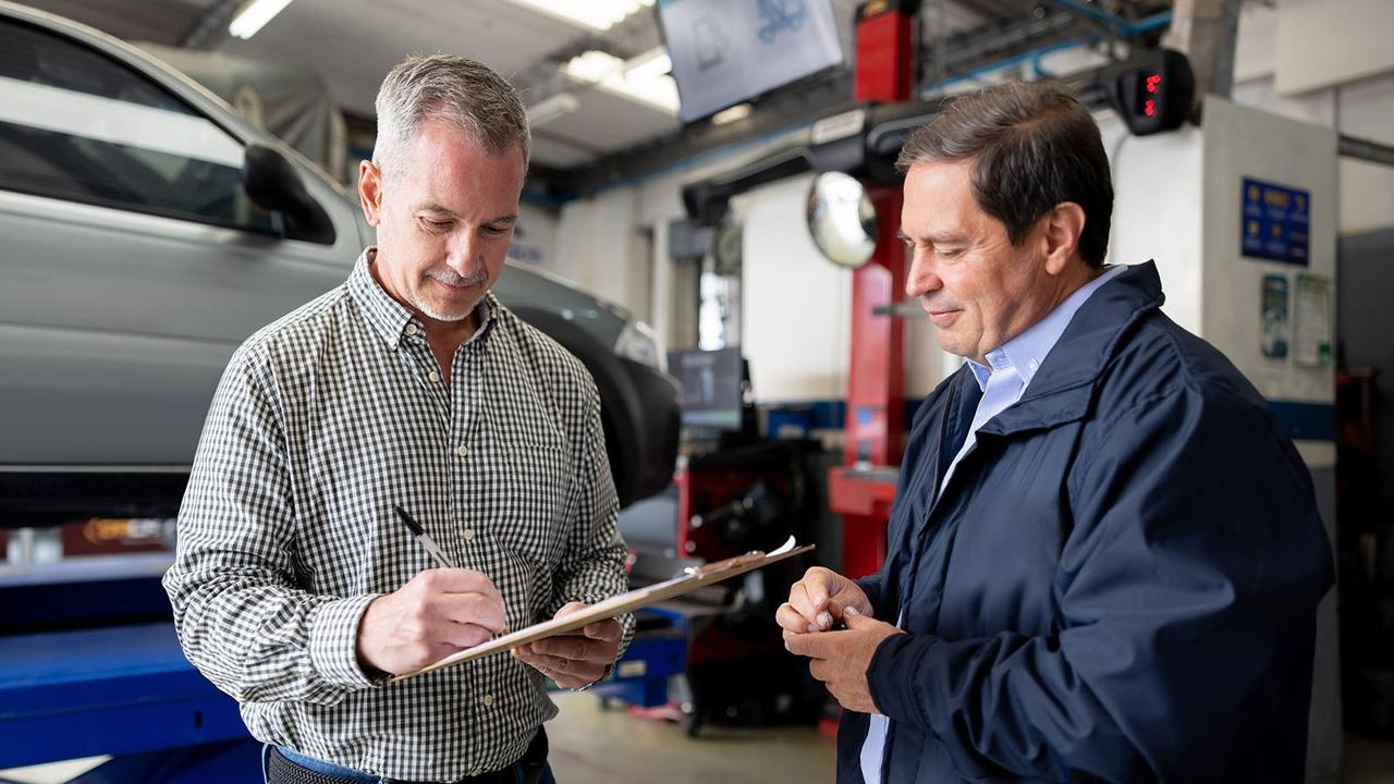 Customer signing forms at car service centre