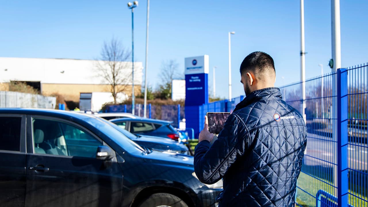 Motorpoint sales executive inspects a car for sale