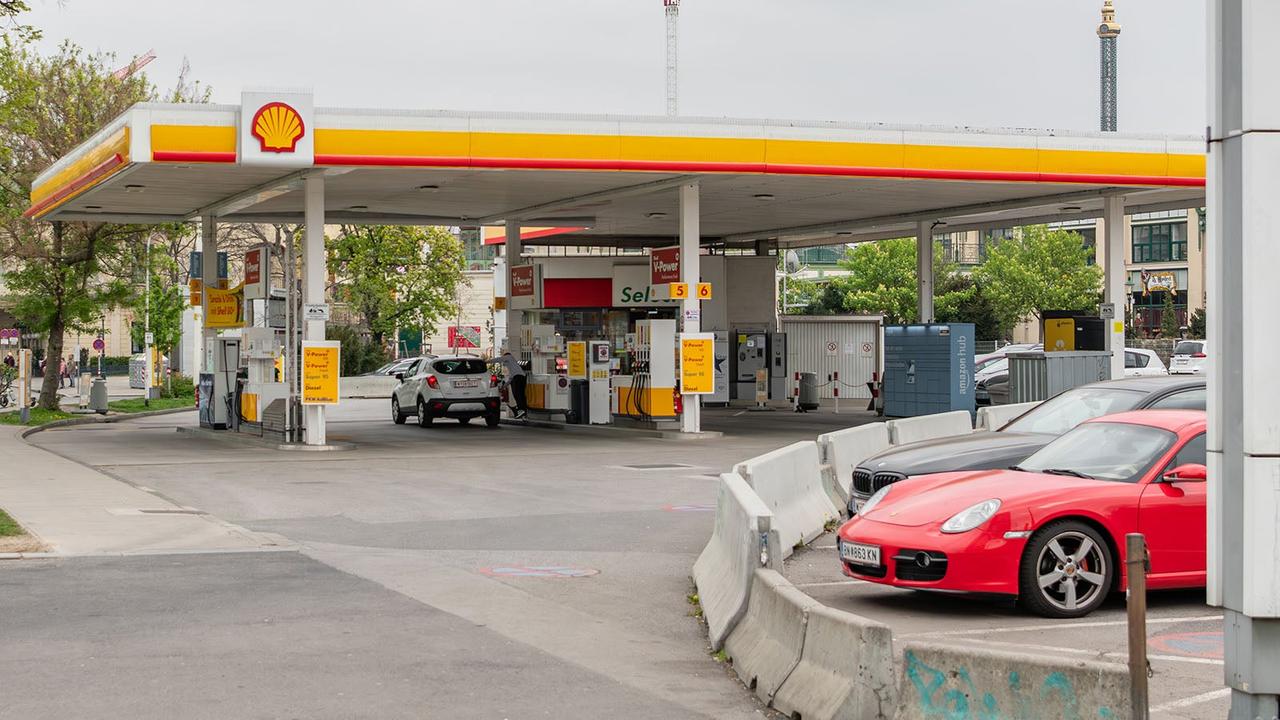 Shell petrol station with Porsche Cayman in foreground