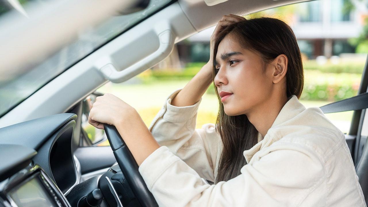 Concerned driver thinking behind the wheel
