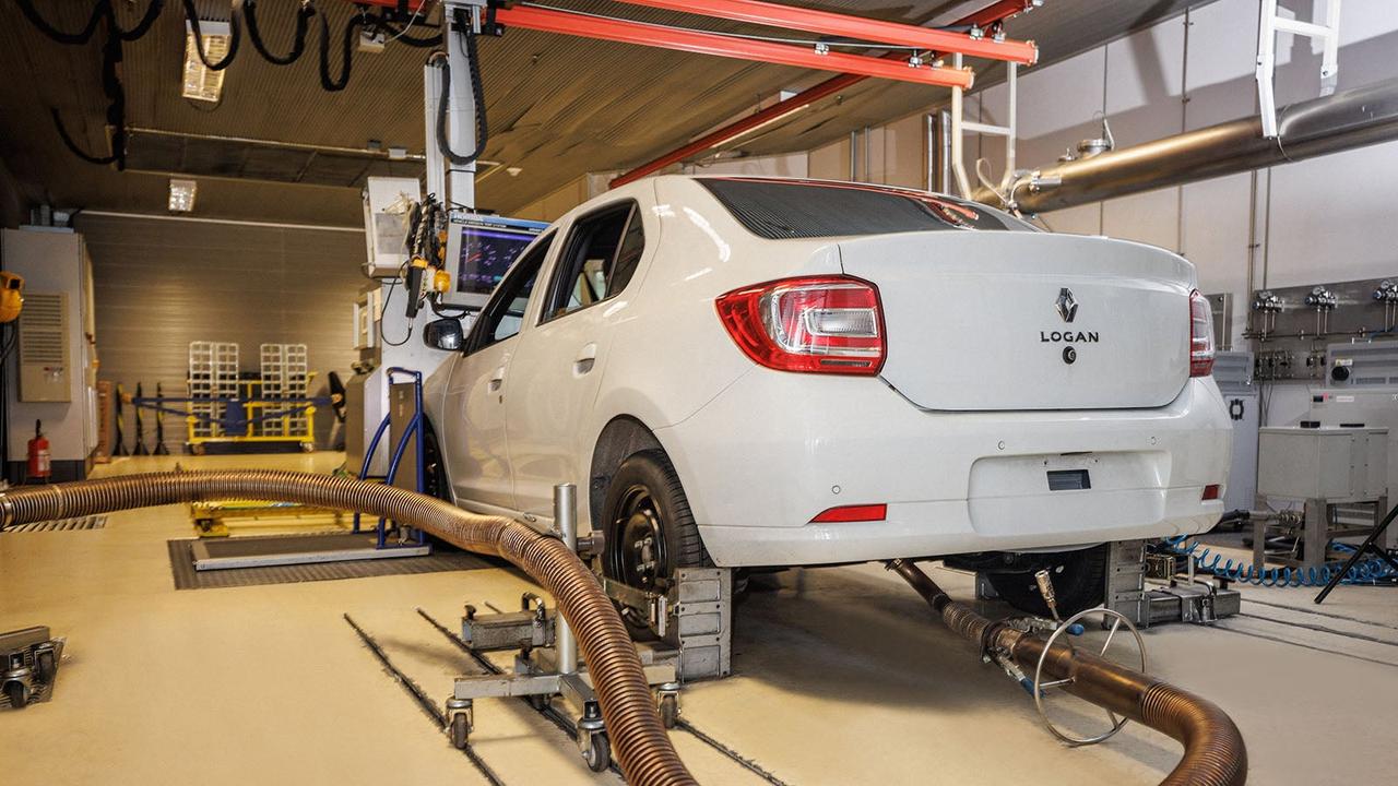 White car undergoing emissions testing in a lab