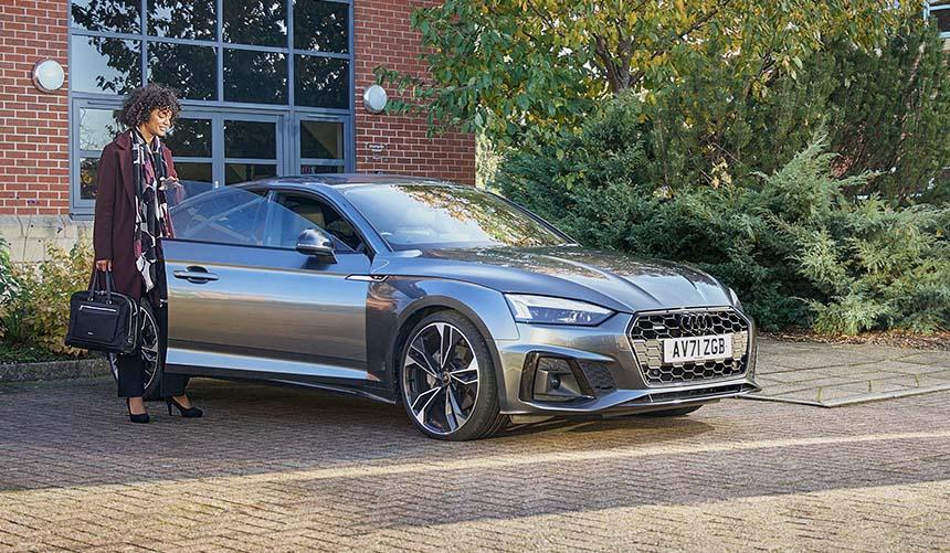 Woman next to car at the office