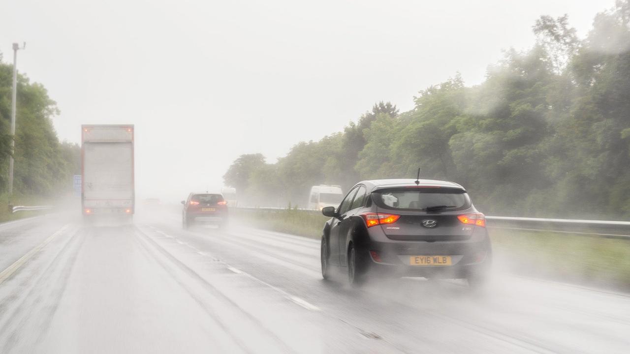 Cars driving in the rain on a UK main road