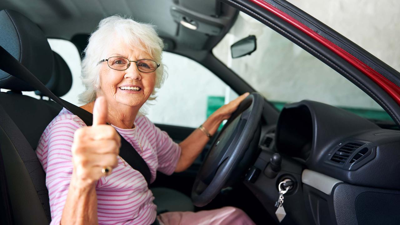 Elderly driver giving thumbs up