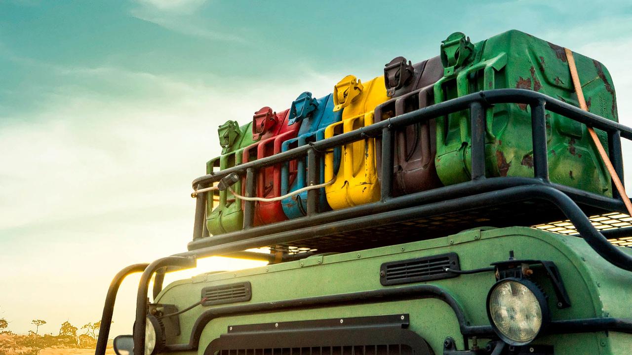 Colourful jerry cans on the roof of a Land Rover