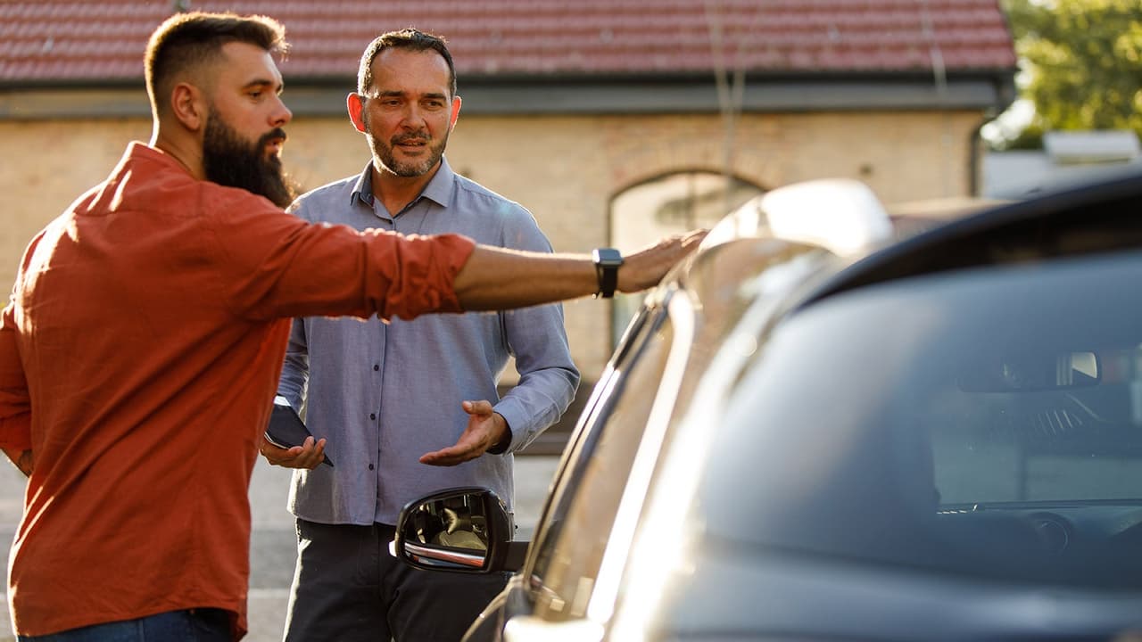 Car buyer and seller discuss car for sale