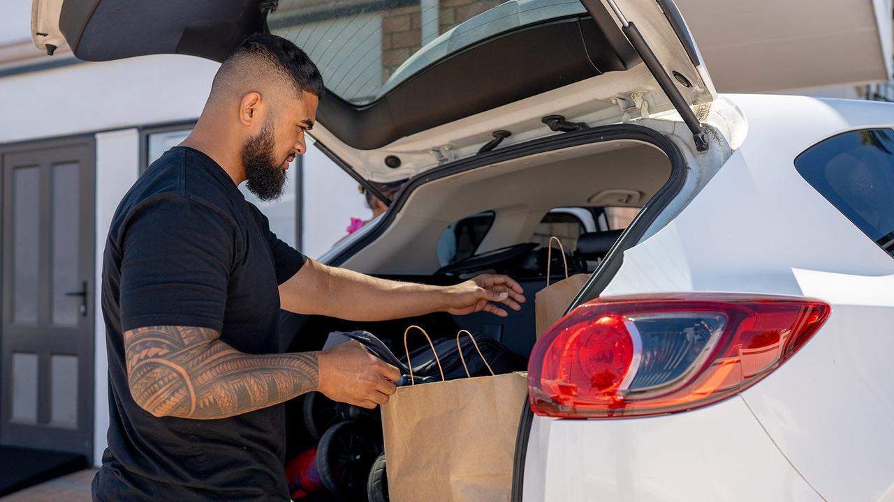 Man getting stuff out a car's boot
