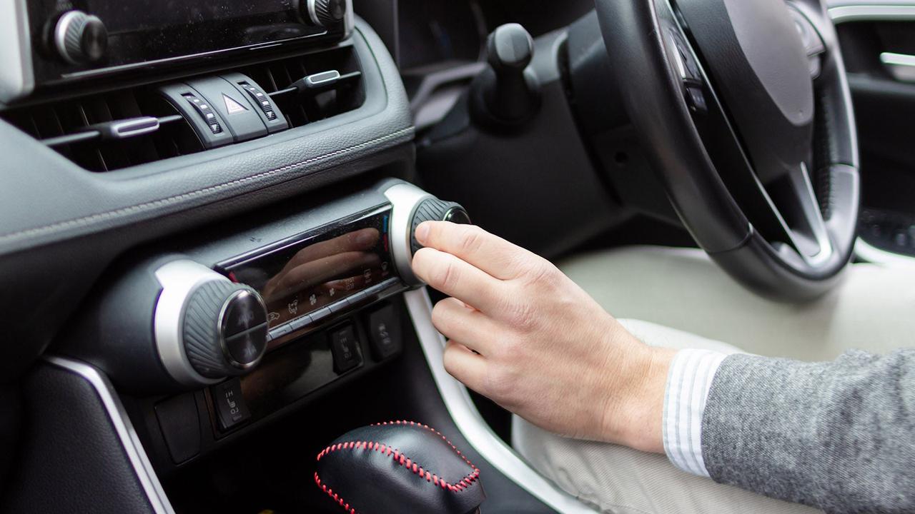Person adjusting climate control