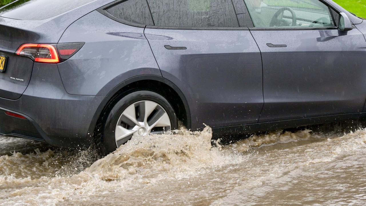 Tesla Model Y driving through flood water