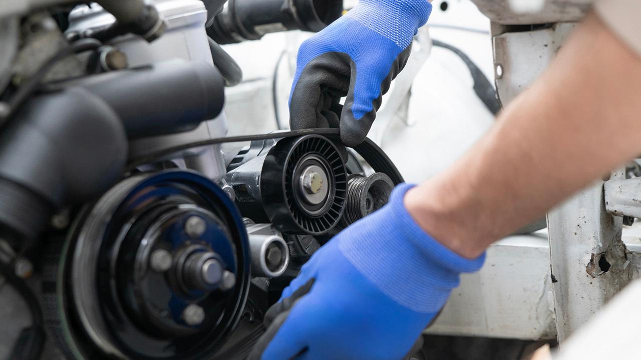 Technician changing timing belt