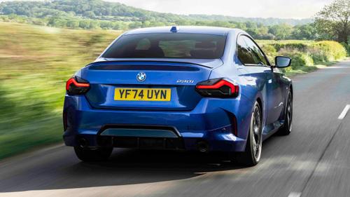 BMW 2 Series coupe driving rear view