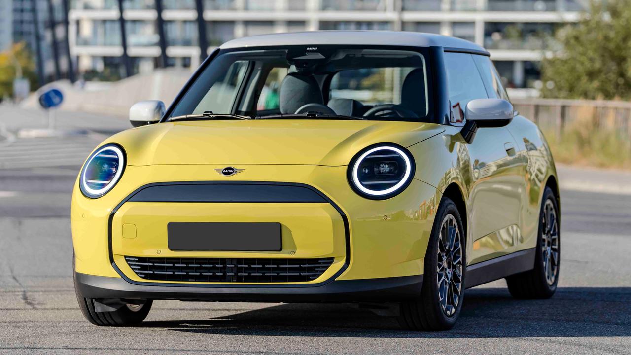 2024 Mini Cooper E in Classic trim with optional Sunny Side Yellow paint, black roof and 17-inch alloy wheels