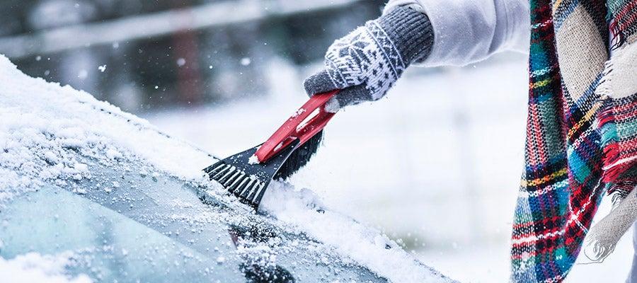 Driver scraping ice off their windscreen