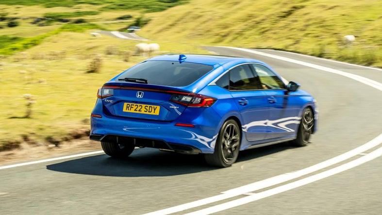 Honda Civic driving around a corner, rear view